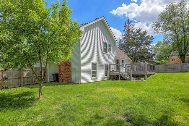 back of property with a deck and stairway