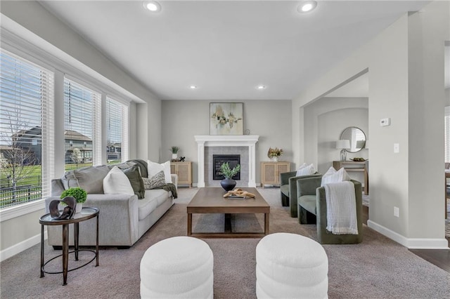 16967 S Laurelwood St, Olathe, KS 66062 - carpeted living room featuring baseboards, recessed lighting, and a tile fireplace