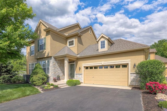 16141 Linden St, Stilwell, KS 66085 - view of front of property with stone siding, driveway, a garage, and stucco siding