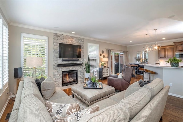 16141 Linden St, Stilwell, KS 66085 - living area featuring dark wood-style flooring, plenty of natural light, a stone fireplace, baseboards, and recessed lighting
