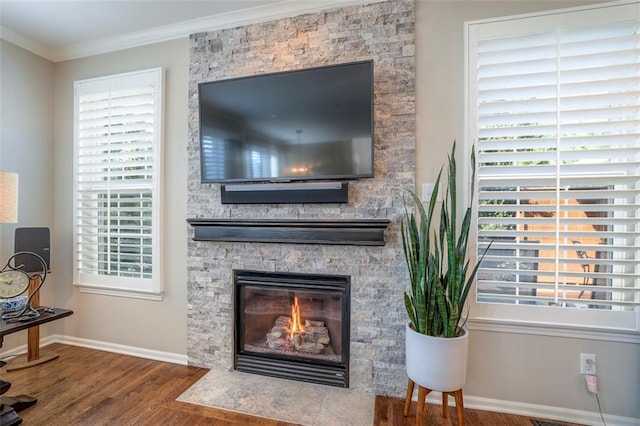 16141 Linden St, Stilwell, KS 66085 - detailed view of crown molding, wood finished floors, baseboards, and a fireplace