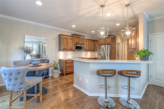 16141 Linden St, Stilwell, KS 66085 - kitchen featuring stainless steel appliances, brown cabinetry, backsplash, light countertops, and ornamental molding