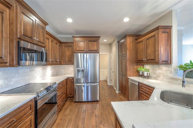 16141 Linden St, Stilwell, KS 66085 - kitchen with appliances with stainless steel finishes, a sink, dark wood finished floors, recessed lighting, and backsplash