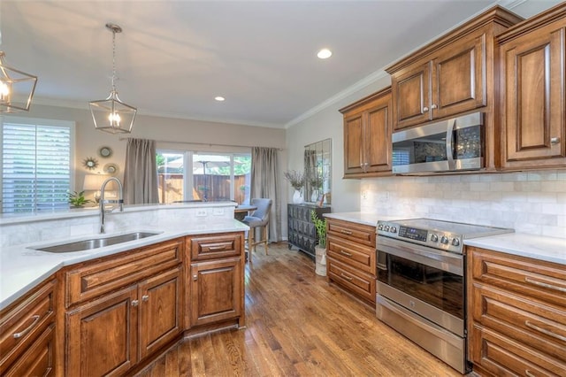 16141 Linden St, Stilwell, KS 66085 - kitchen with appliances with stainless steel finishes, a sink, dark wood finished floors, tasteful backsplash, and recessed lighting