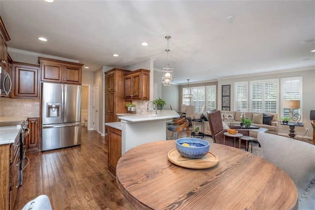 16141 Linden St, Stilwell, KS 66085 - dining space featuring recessed lighting, dark wood finished floors, ornamental molding, and a chandelier
