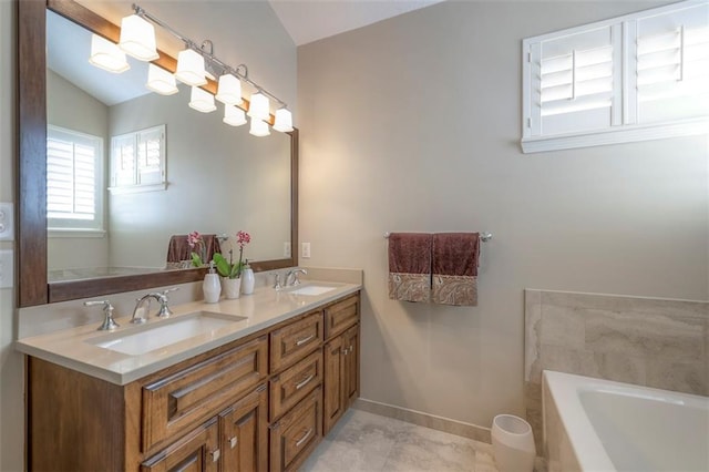 16141 Linden St, Stilwell, KS 66085 - full bath with lofted ceiling, a bathtub, double vanity, baseboards, and tile patterned floors