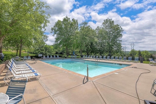 16141 Linden St, Stilwell, KS 66085 - community pool featuring a patio, view of scattered trees, and fence