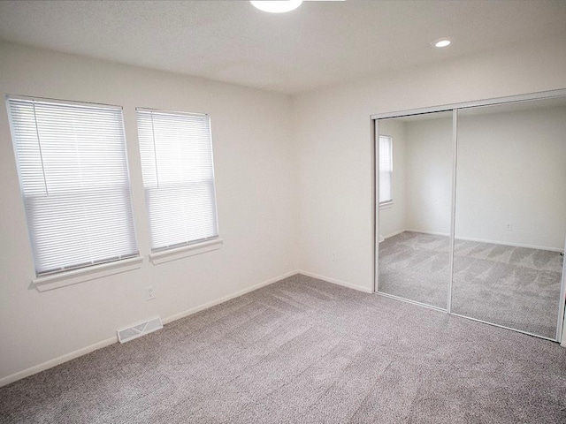 10921 Mckinley Dr, Kansas City, MO 64134 - unfurnished bedroom featuring carpet, a closet, baseboards, and recessed lighting