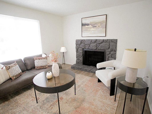 10921 Mckinley Dr, Kansas City, MO 64134 - living area featuring wood finished floors and a stone fireplace