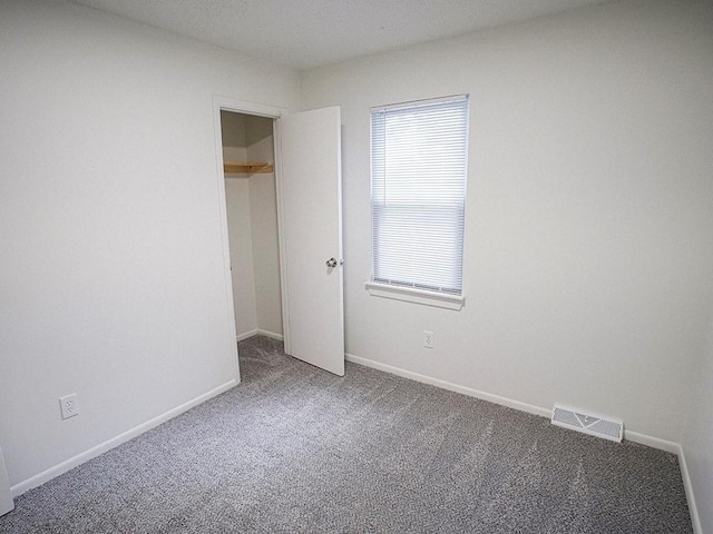 10921 Mckinley Dr, Kansas City, MO 64134 - unfurnished bedroom with carpet flooring and baseboards