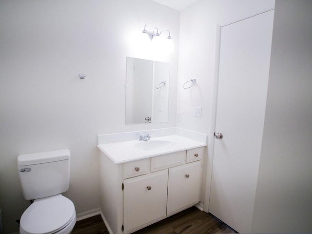 10921 Mckinley Dr, Kansas City, MO 64134 - half bath featuring vanity, toilet, and wood finished floors