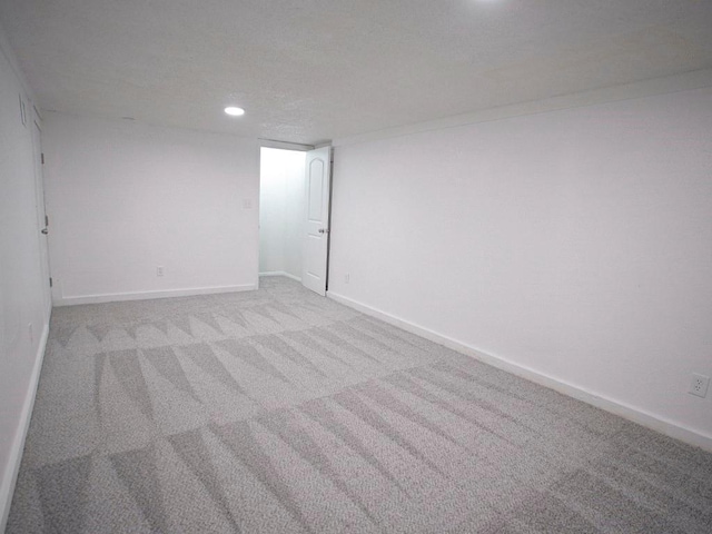 10921 Mckinley Dr, Kansas City, MO 64134 - spare room with recessed lighting, light carpet, and baseboards