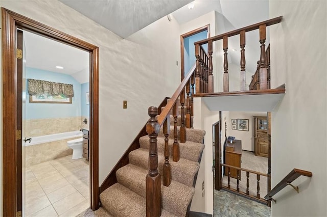 stairway with tile patterned flooring