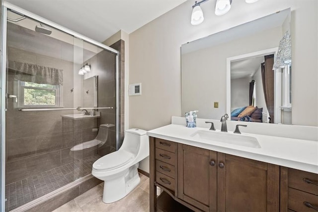 bathroom featuring toilet, vanity, tile patterned flooring, and a shower stall