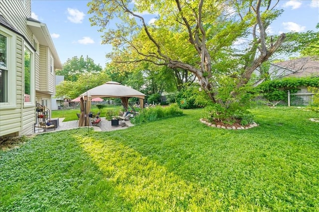 view of grassy yard featuring a gazebo and a patio