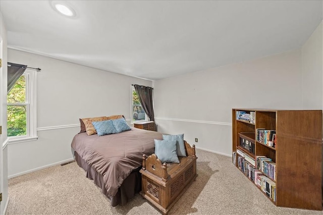 carpeted bedroom featuring baseboards