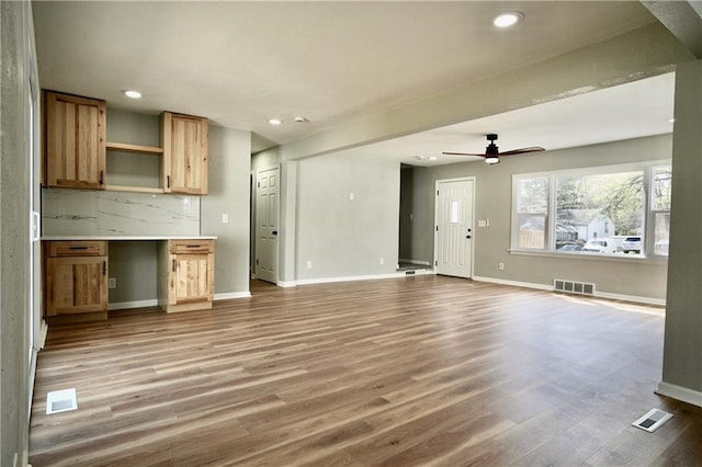 10514 E 35th St S, Independence, MO 64052 - unfurnished living room featuring baseboards, wood finished floors, recessed lighting, and a ceiling fan