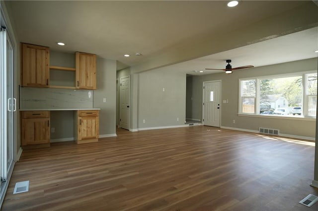 10514 E 35th St S, Independence, MO 64052 - unfurnished living room featuring dark wood-style floors, baseboards, recessed lighting, and a ceiling fan