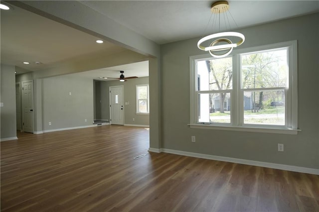 10514 E 35th St S, Independence, MO 64052 - unfurnished dining area with baseboards, wood finished floors, a chandelier, recessed lighting, and ceiling fan