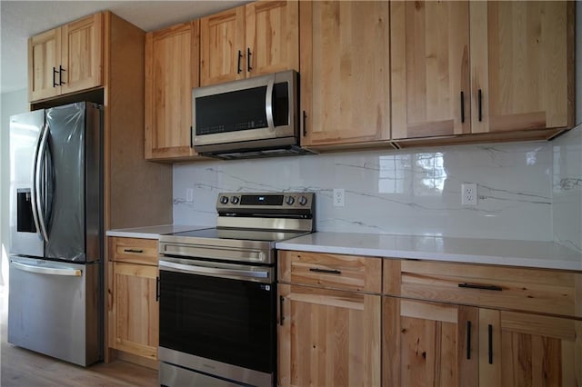 10514 E 35th St S, Independence, MO 64052 - kitchen with appliances with stainless steel finishes, light brown cabinets, and light countertops