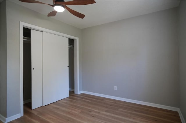 10514 E 35th St S, Independence, MO 64052 - unfurnished bedroom featuring wood finished floors, baseboards, and a closet