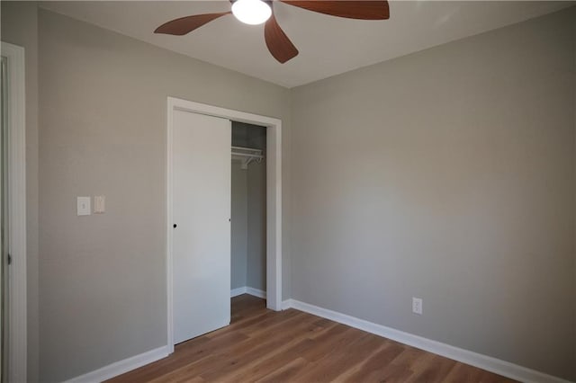 10514 E 35th St S, Independence, MO 64052 - unfurnished bedroom with wood finished floors, a closet, baseboards, and ceiling fan