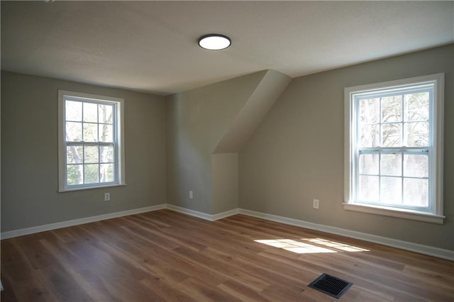 10514 E 35th St S, Independence, MO 64052 - additional living space with wood finished floors, baseboards, and vaulted ceiling