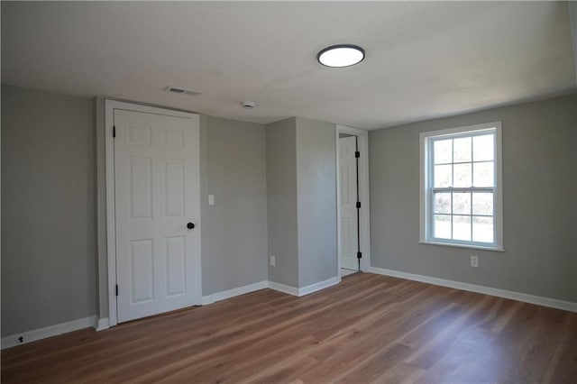 10514 E 35th St S, Independence, MO 64052 - spare room featuring wood finished floors, baseboards, and a smoke detector