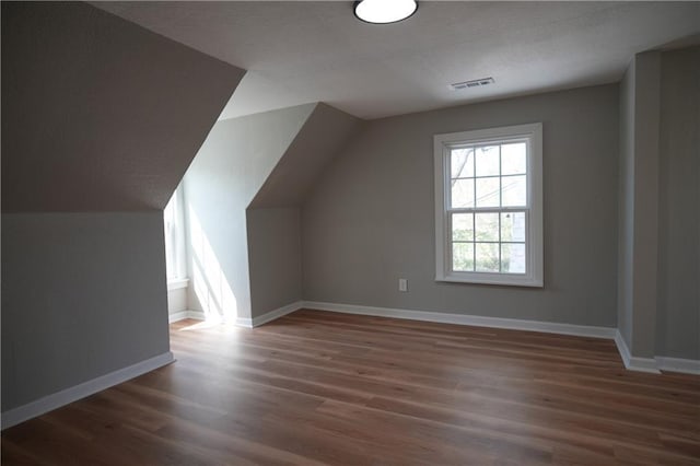 10514 E 35th St S, Independence, MO 64052 - bonus room featuring wood finished floors, vaulted ceiling, and baseboards