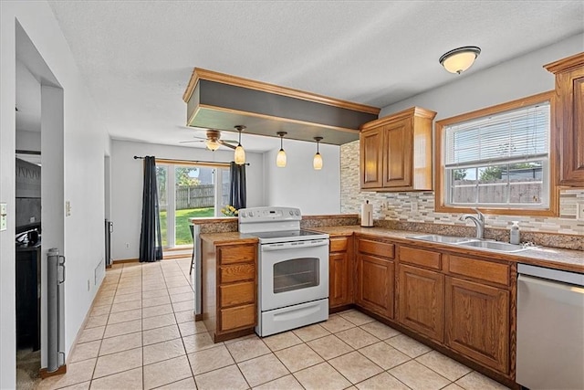 kitchen featuring white electric range oven, dishwasher, a sink, tasteful backsplash, and light tile patterned floors