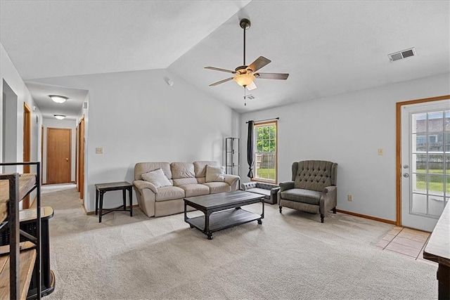 living area with light colored carpet, vaulted ceiling, ceiling fan, and baseboards