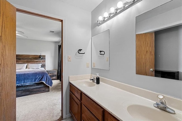 ensuite bathroom featuring double vanity and a ceiling fan