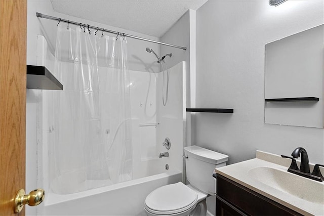 bathroom with toilet, shower / bath combo, vanity, and a textured ceiling