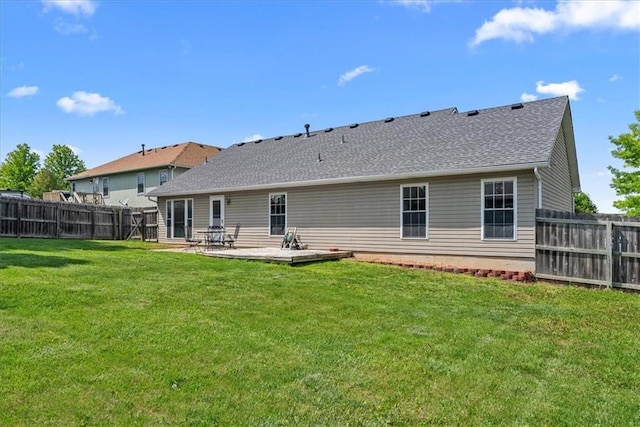 rear view of house featuring a shingled roof