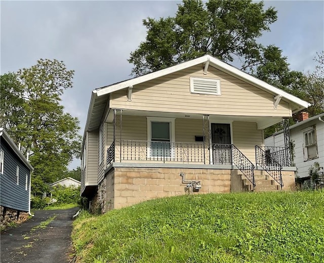 3624 Mersington Ave, Kansas City, MO 64128 - view of front of house featuring a porch and asphalt driveway