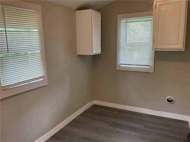 3624 Mersington Ave, Kansas City, MO 64128 - laundry room with dark wood-style flooring and baseboards