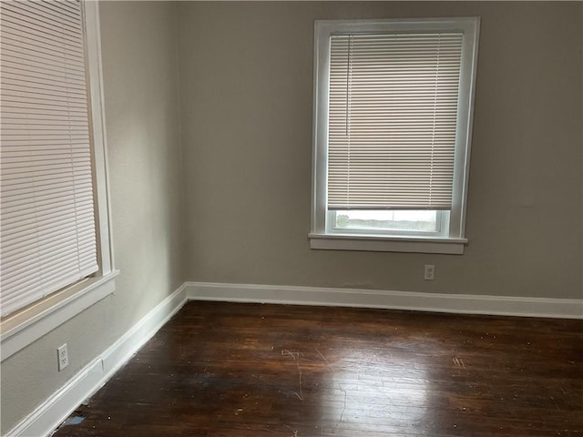 3624 Mersington Ave, Kansas City, MO 64128 - empty room with baseboards and dark wood-type flooring