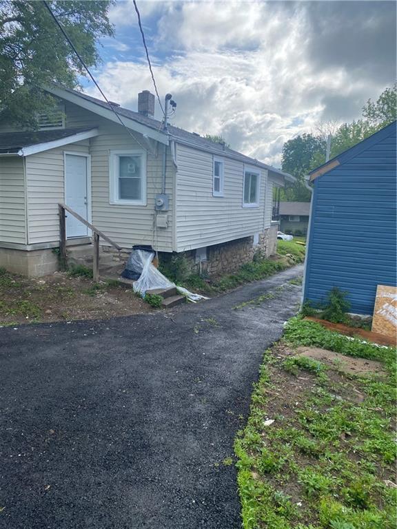 3624 Mersington Ave, Kansas City, MO 64128 - view of side of property with entry steps and a chimney