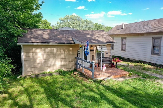 817 S Hardy Ave, Independence, MO 64053 - rear view of house with a lawn, a deck, and a shingled roof