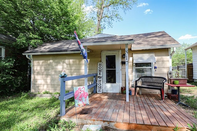 817 S Hardy Ave, Independence, MO 64053 - view of front of home featuring roof with shingles and a wooden deck