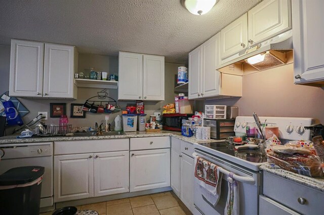 817 S Hardy Ave, Independence, MO 64053 - kitchen featuring electric range, under cabinet range hood, a sink, dishwasher, and white cabinets