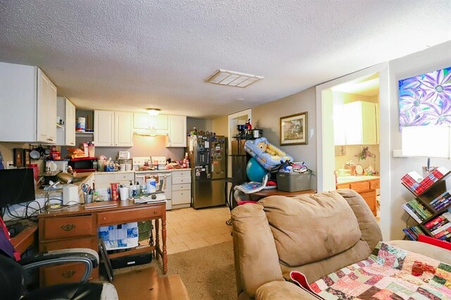 817 S Hardy Ave, Independence, MO 64053 - living room with a textured ceiling and light tile patterned floors