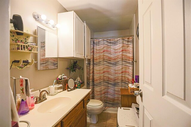 817 S Hardy Ave, Independence, MO 64053 - bathroom featuring toilet, vanity, tile patterned flooring, and curtained shower