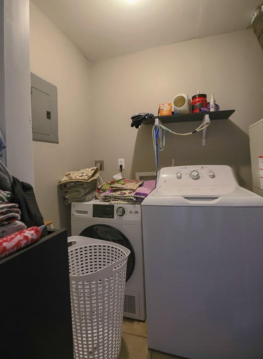 817 S Hardy Ave, Independence, MO 64053 - laundry room featuring electric panel, separate washer and dryer, and light tile patterned floors