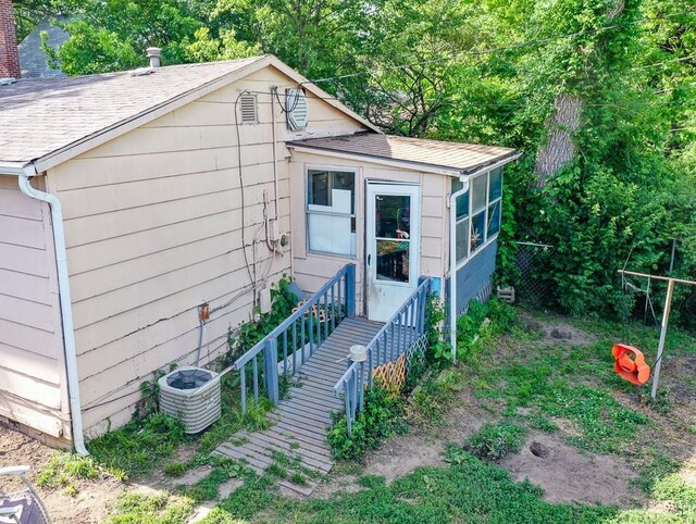 817 S Hardy Ave, Independence, MO 64053 - view of front of property with central air condition unit and a shingled roof
