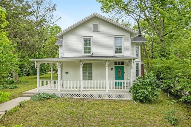view of front of property featuring covered porch and a front yard