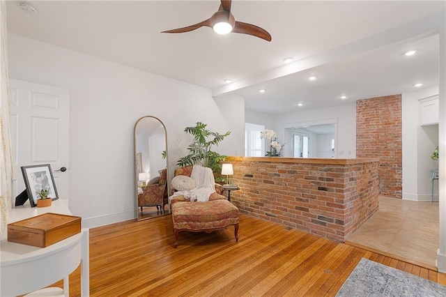 living area with a ceiling fan, light wood-type flooring, recessed lighting, and baseboards