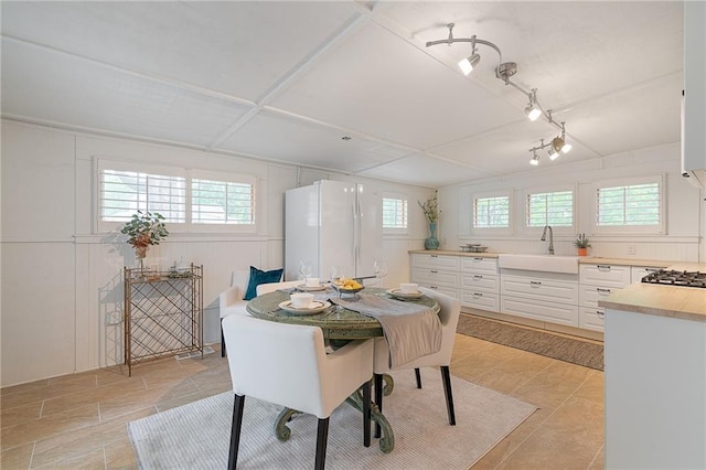 dining space featuring rail lighting