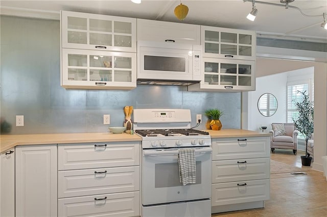 kitchen with white appliances, light countertops, white cabinetry, and glass insert cabinets