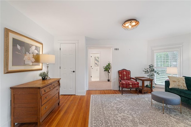 living area featuring light wood-style flooring and baseboards